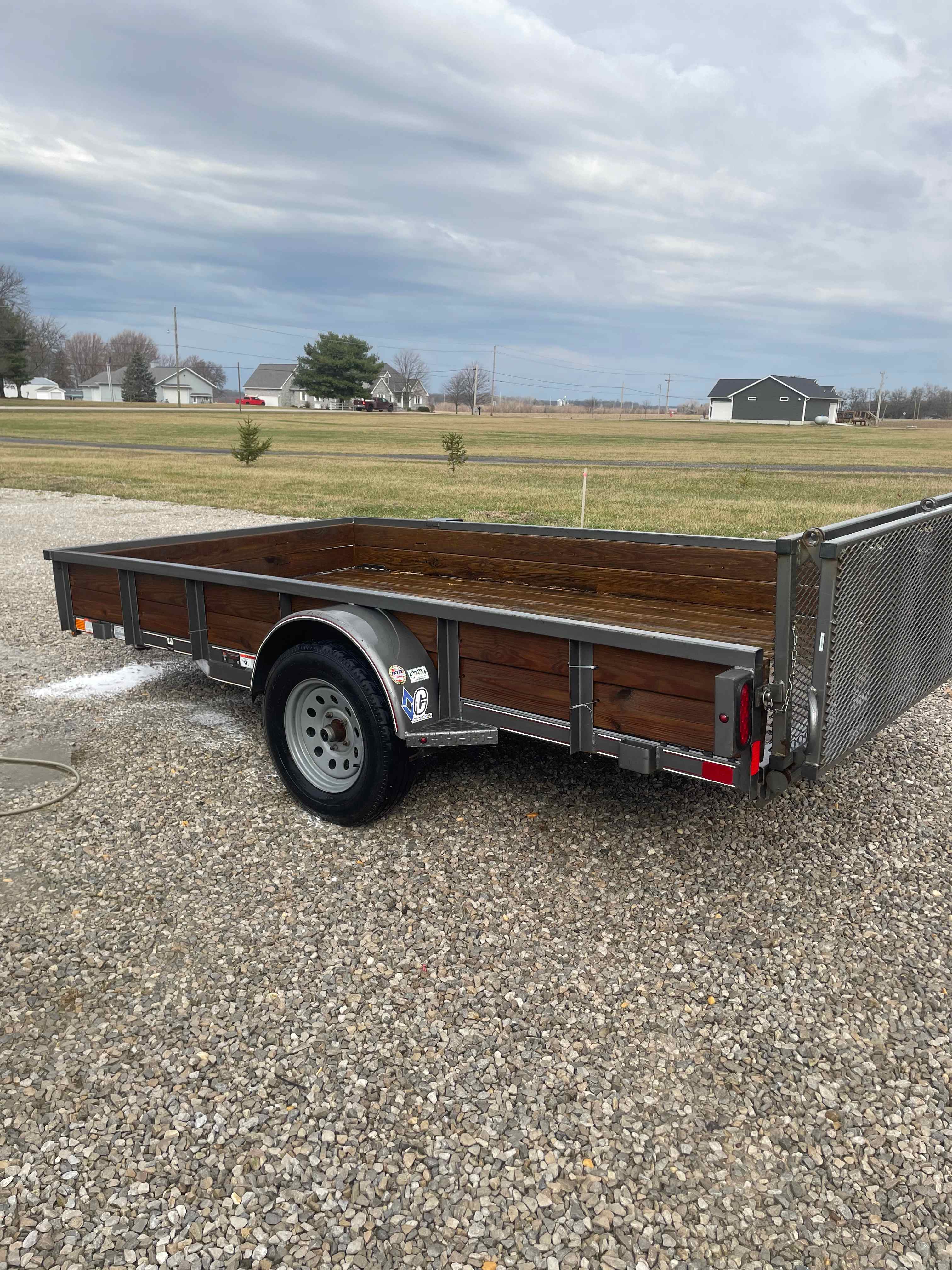 Utility trailer with wood-lined bed available for rent